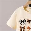 imageGirls Graphic Tees Short Sleeve Bow Print Tee Tops Crew Neck Drop Shoulder Casual Summer T ShirtsBow Apricot